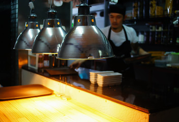 food lamp use for warm food,chef working in kitchen ,blurred pic