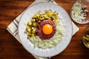 Steak tartare with egg yolk, onions and pickles
