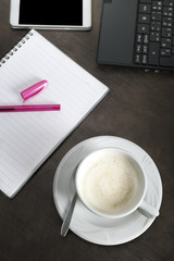 Blank notepad, phone, laptop and coffee cup