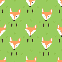 Cute pattern with a muzzle and paws foxes and grass