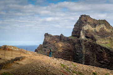Fototapeta premium Tourists at the eastern cape, famous hiking trail of Madeira island