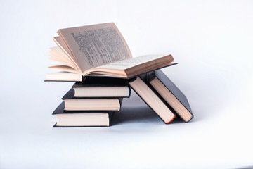 Naklejka premium A stack of books lying on a white background, learning, education, study