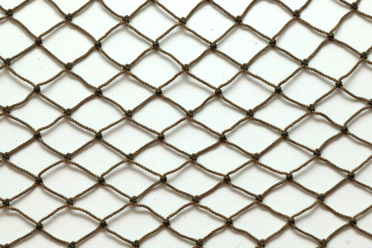 Close up of fish net against white background