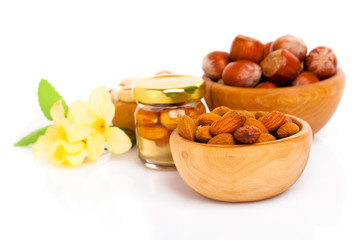 Fototapeta na wymiar Hazelnuts in a wooden bowl on white background