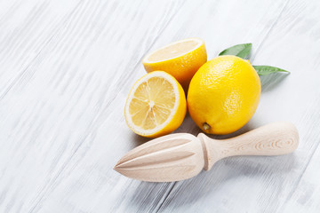 Fresh ripe lemons and juicer