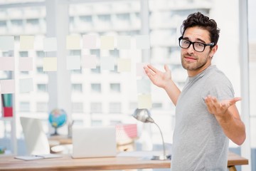 Man shrugging his shoulder in office