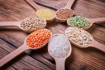 Assortment of cereals in wooden spoons