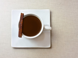 Cup of dark hot chocolate with cinnamon stick