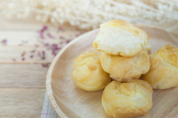 Vanilla cream eclairs on wood table