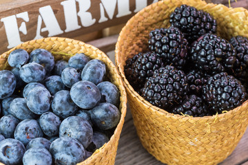 Baskets with fresh, organic, farm blueberries and blackberries.