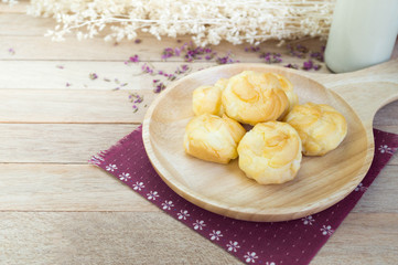 Vanilla cream eclairs on wood table