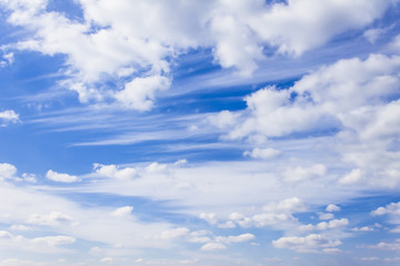 Obraz premium White cirrus clouds and a bright blue sky. Bright, high-contrast picture, nature.
