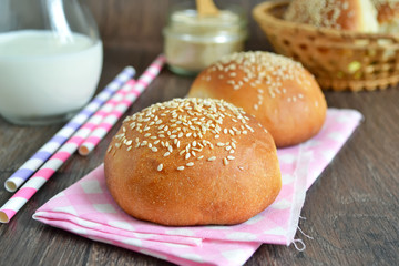 homemade buns with sesame seeds and milk for breakfast