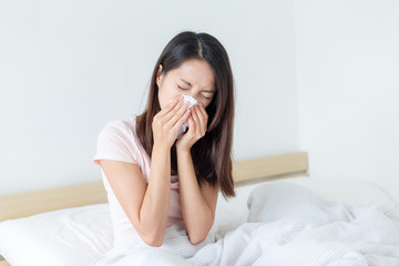 Woman sneeze on bed