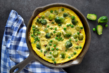 Frittata with cheese, green peas and Brussels sprouts