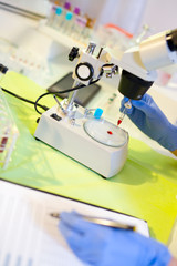 Woman in a laboratory working with a microscope, selective focus