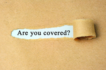 Are you covered? word written under torn brown paper.