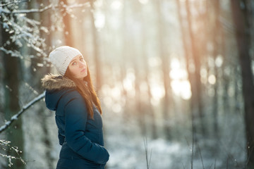 Young woman on a walk in snowy winter