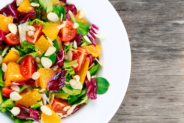 Fresh Orange, vegetables salad. on wooden table.
