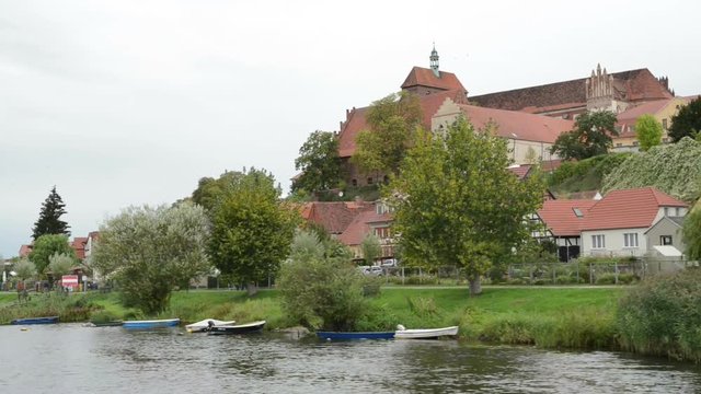 driving with boat along havel river. typical landscape with meadows and willow tries. Havelland region. (Germany)