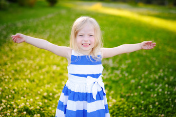 Portrait of cute little cheerful girl outdoors