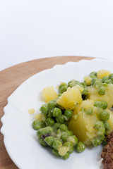 Potato and green peas salad on the plate