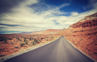 Vintage stylized picture of a desert road, USA