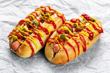 Hot Dogs with sausage, onion, pickles mustard and ketchup. 
