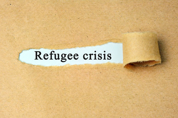 Torn paper with  "refugee crisis" text.