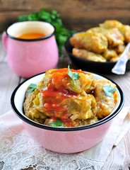 Stuffed cabbage rolls with rice and meat in tomato sauce