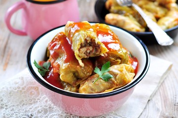Stuffed cabbage rolls with rice and meat in tomato sauce