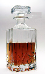 Whiskey Decanter half full with spirit on white background