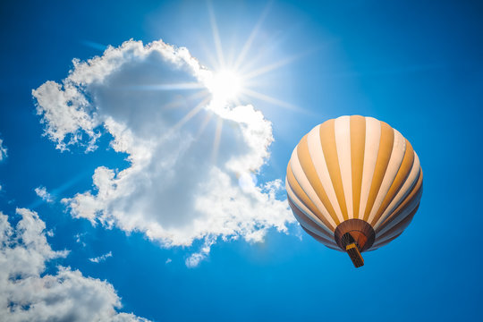 hot air balloon with blue cloudy sky background