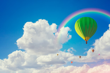 Fototapeta premium colorful hot air balloons and rainbow with cloudy blue sky background