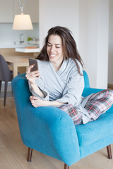 Woman sitting in sofa in the living room. Morning scene