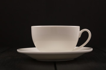 Cappuccino with cinnamon in a white cup. Coffee on Black Wooden Table