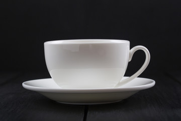 Cappuccino with cinnamon in a white cup. Coffee on Black Wooden Table