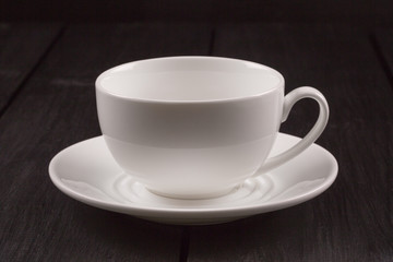 Cappuccino with cinnamon in a white cup. Coffee on Black Wooden Table