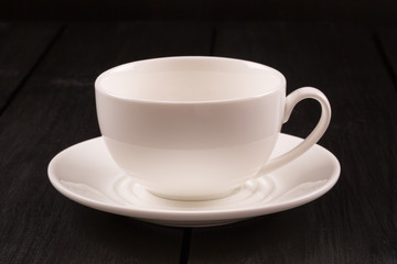Cappuccino with cinnamon in a white cup. Coffee on Black Wooden Table