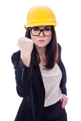 angry business woman architect in yellow helmet showing her fist