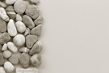 Fototapeta na wymiar smooth river stone on gray background. zen like concepts. Free space for text. copy space. black and white image