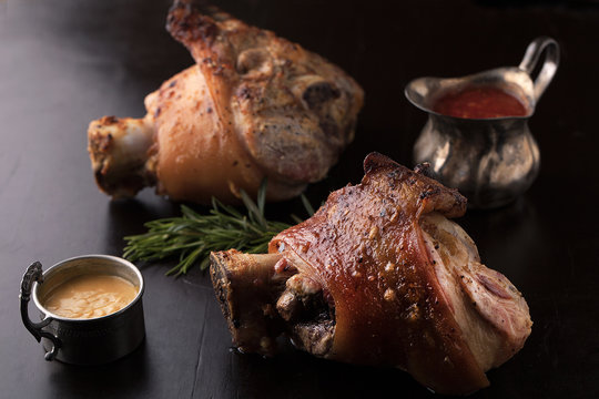 Roasted pork knuckle with mustard, spices and rosemary