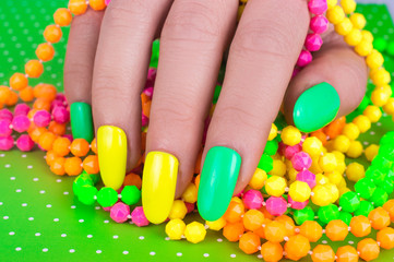 Fototapeta na wymiar Fashionable Stylish Colorful nails and nail polish on a bright background. Manicure nail painting. Beauty hands.