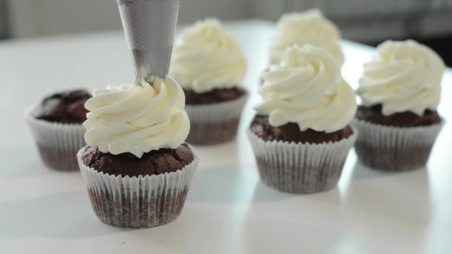 Woman decorated cupcakes with decorations