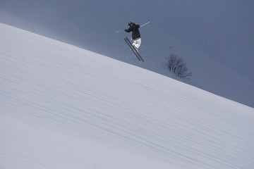 Flying skier on mountains. Extreme sport.