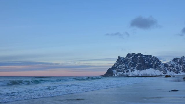 Waves at Utakliev beach in the Lofoten archipel in Norway during sunset at the end of a beautiful winter day.