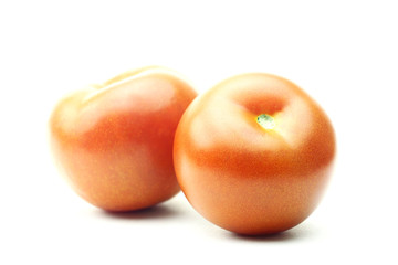 Two fresh tomatoes isolated on white background