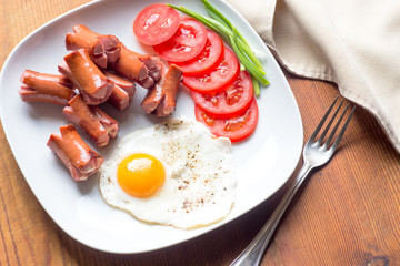 Omlette, grilled sausages, tomato view from the top