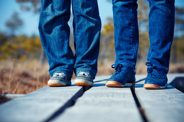 Close-up of female and kid feets in sneakers running outdoors