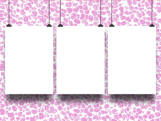 Close-up of three blank frames hanged by clips against pink stained abstract background
